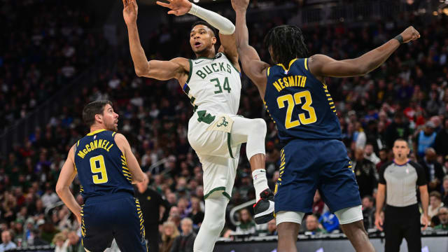 Milwaukee Bucks forward Giannis Antetokounmpo (34) passes the ball against Indiana Pacers center Aaron Nesmith (23)